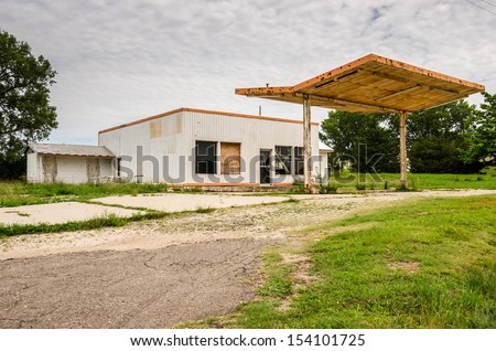 Vacant service station and canopy with fluorescent tubes still attached
