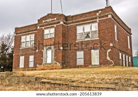 Abandoned brick school building in a mostly ghost town