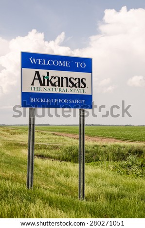 State of Arkansas welcome sign tells you it is The Natural State and to buckle up for safety