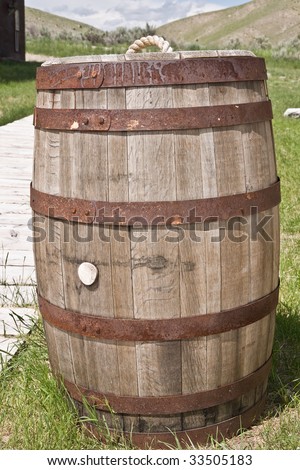 Wooden barrel, or cask, with rusted iron hoops used as a trash can