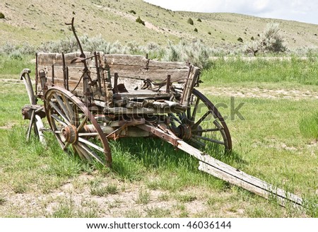 Dilapidated wooden wagon with broken, leaning wheels