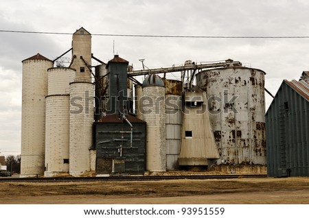 Grain elevators along railroad tracks in a small midwestern town in the US
