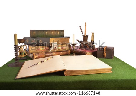 Desk with an open book and old stationery. Isolated on white. Books and pictures of pictures published from 1892 to 1896 years.