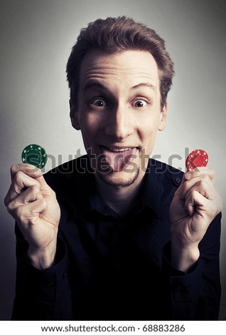 Happy face of poker player holding poker chips.