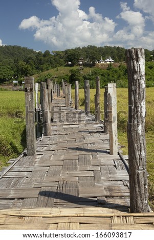 The old bamboo bridge in rice field, north Thailand