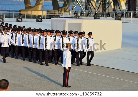 SINGAPORE - AUGUST 09: Military Contingent marching past Parade Commander LTC Clarence Tan during National Day Parade 2012 on August 09, 2012 in Singapore