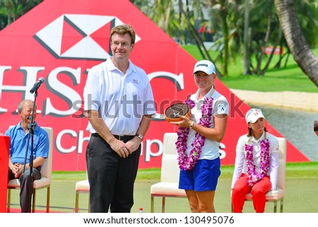 SINGAPORE - MARCH 3: Stacy Lewis and Guy Harvey Samuel, CEO HSBC Singapore, pose for the cameras during HSBC Women\'s Champions prize presentation at the Sentosa Golf Club on March 3, 2013, Singapore.