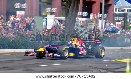 SINGAPORE - APRIL 24: David Coulthard, performing donuts in Redbull Racing Car on the streets of Orchard Road in Red Bull Speed Street Singapore on April 24, 2011 in Singapore.