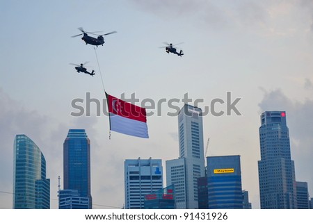 SINGAPORE - AUGUST 9: Chinook helicopter flying Singapore national flag at National Day Parade Singapore 2011 on August 9, 2011 in Singapore.