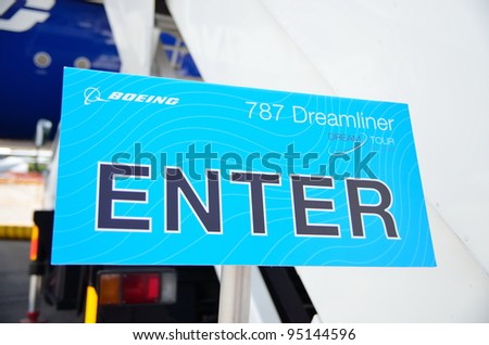SINGAPORE - FEBRUARY 12: Enter dream tour signage beside Boeing 787 Dreamliner at Singapore Airshow February 12, 2012 in Singapore