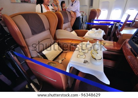 SINGAPORE - FEBRUARY 17: First class cabin with dining set on display in Singapore Airlines\' (SIA) last Boeing 747-400 aircraft at Singapore Airshow on February 17, 2012 in Singapore
