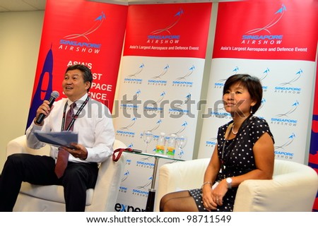 SINGAPORE - FEBRUARY 17: Mr Jimmy Lau, Managing Director of Experia Events and Ms Angelica Lim (General Manager) speaking at the media briefing at Singapore Airshow February 17, 2012 in Singapore