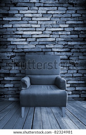 old single sofa seat in front of the wall