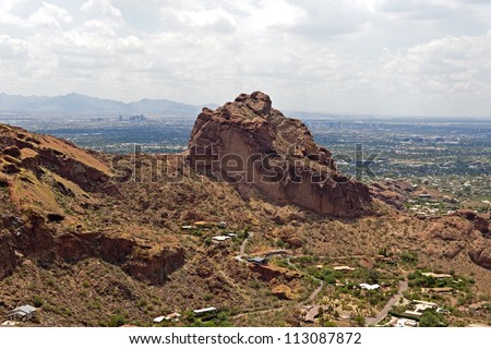 Hiking up Camelback Mountain with the Phoenix, Arizona skyline in the distance