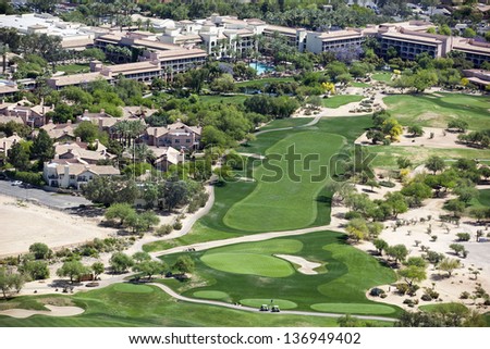 Beautiful golf course next to a luxury resort as viewed from a helicopter