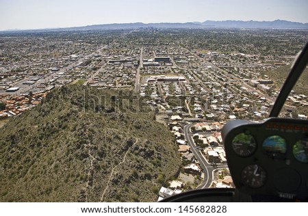 Aerial view through the bubble of a helicopter at the Phoenix, Arizona skyline