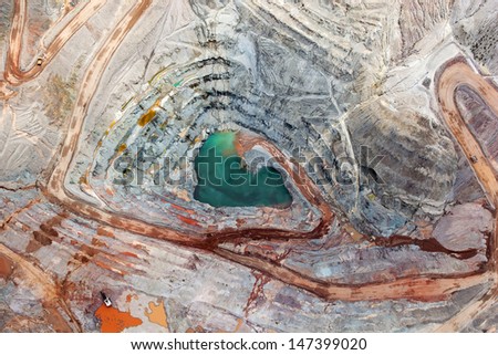Brilliant colors explode in a vertical view of an open pit mining from above
