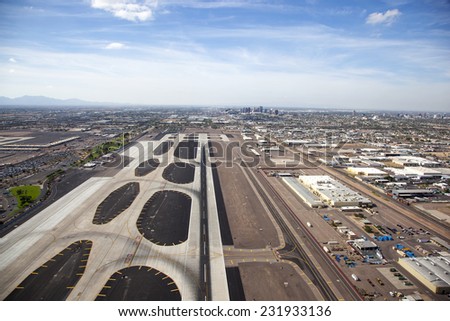 Runway at Sky Harbor airport with Phoenix, Arizona skyline