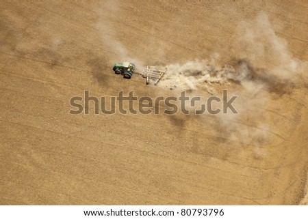 of tractor tilling soil