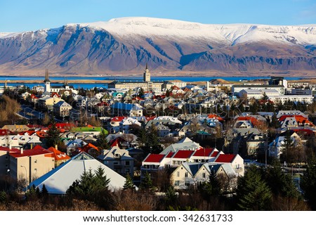 Aerial view of Reykjavik, Iceland with snow capped mountains in the background