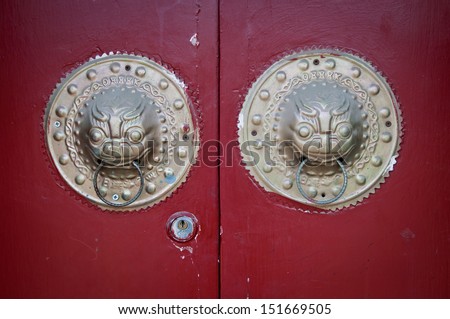brass dragon head door knockers in traditonal residence in hutong area in Beijing, China