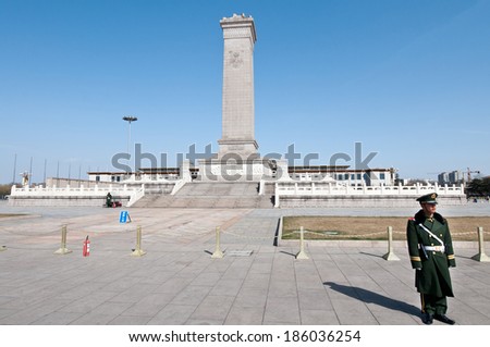 BEIJING, CHINA - MARCH 27: Chinese soldiers stands on attention in front of Monument to the People\'s Heroes on Tiananmen Square on March 27, 2013 in Beijing