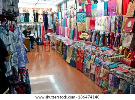 SHANGHAI, CHINA - MARCH 21: Saleswoman sits in small clothes and textiles shop at Fangbang Road old street on Old City area on March 21, 2013 in Shanghai