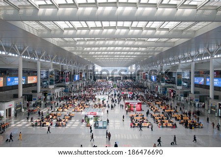 SHANGHAI, CHINA - MARCH 25: crowd of passengers waits for a transport on one of the four major railway stations in Shanghai - Shanghai Hongqiao Railway Station on March 25, 2013 in Shanghai