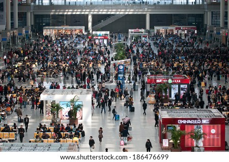 SHANGHAI, CHINA - MARCH 25: crowd of passengers waits for a transport on one of the four major railway stations in Shanghai - Shanghai Hongqiao Railway Station on March 25, 2013 in Shanghai