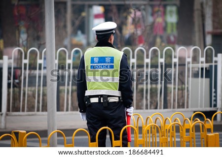 BEIJING, CHINA - MARCH 31: Chinese traffic police officer stands on duty on the street on March 31, 2013 in Beijing