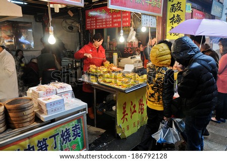 SHANGHAI, CHINA - MARCH 24: people buy food on a bazaar in Shanghai on March 24, 2013 in Shanghai