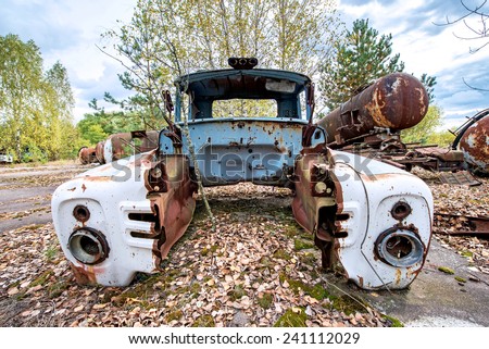 rusty wreck on junk yard near Illinci village in Chernobyl Nuclear Power Plant Zone of Alienation, Ukraine