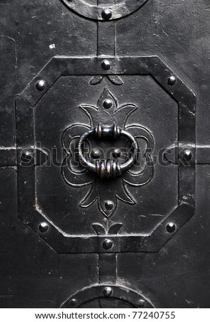solid black iron door with door knocker