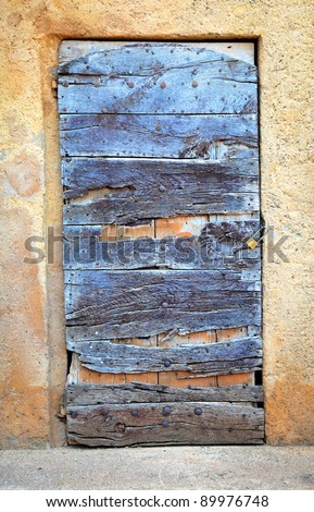 very old wooden ruined door with new padlock