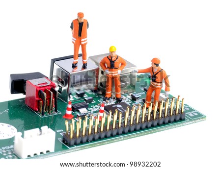 tiny figures of construction engineers examining  integrated circuit