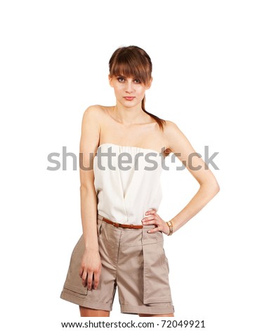 The girl in shorts and a blouse on a white background