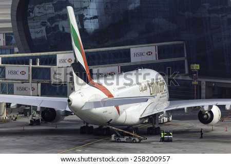 DUBAI - JANUARY 9: An Emirates plane is getting ready for push back and take off as seen on January 9, 2015. Dubai airport\'s traffic is very heavy in the mornings.