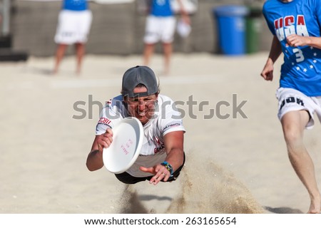 DUBAI - MARCH 12: A female player is playing Frisbee at the Dubai beach World Championships of Beach Ultimate 2015 as seen on March 12, 2015.
