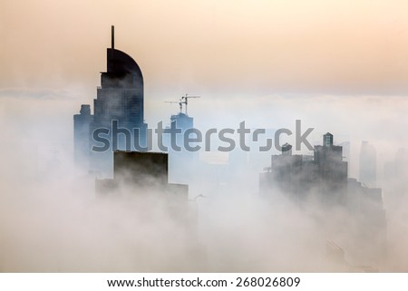 Buildings are covered in thick layer of fog in Dubai downtown.