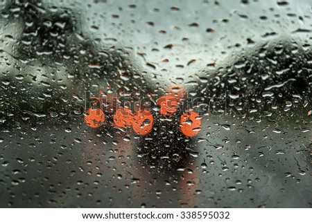 A very rare rainy day in Dubai with car lights visible in distance as seen through car windows with rain drops visible on the window.
