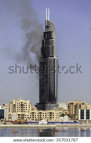 DUBAI - JANUARY 1: The address hotel caught fire on the new years eve. This is the aftermath the next day which still shows the hotel is on fire as seen on January 1, 2016.