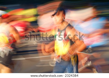 Marathon runners head into the sun during the early stages of a race.