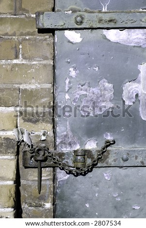 A hasp and staple on an old warehouse door.