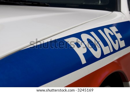 Police sign on the side of a North American cruiser. Shot with shallow depth of field: Focal point is on the letters O and L.