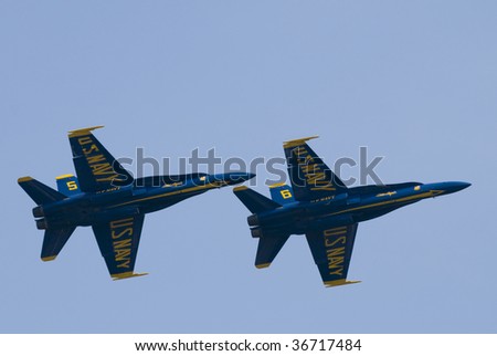 TORONTO, ON - SEPTEMBER 7: Two F/A18 Hornets from the US Navy Blue Angels Flight Demonstration Squadron in formation over the city on the last day of the air show, September 7, 2009 in Toronto, ON.