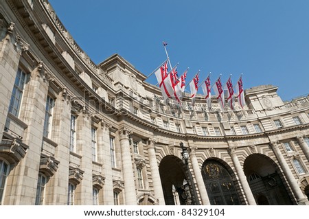 Admiralty Arch in London with eight white ensigns, the flag of the British Royal Navy, flying.