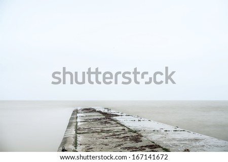 Concrete pier, minimalistic landscape in stormy weather