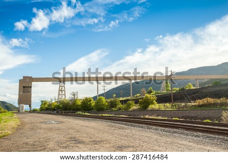 Coal mine infrastructure among beautiful mountains and green grass of USA