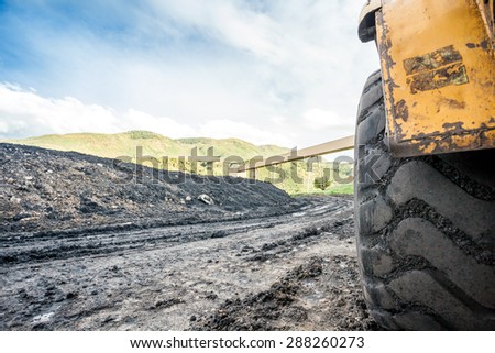 Close up of huge coal mining machines\' tires