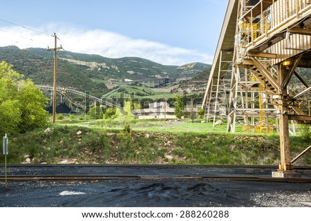 Coal mine infrastructure among beautiful mountains and green grass of USA